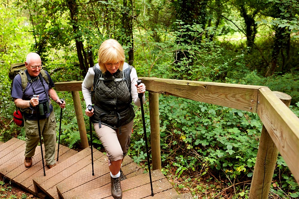 Elderly Couple Climbing Steps Outdoors