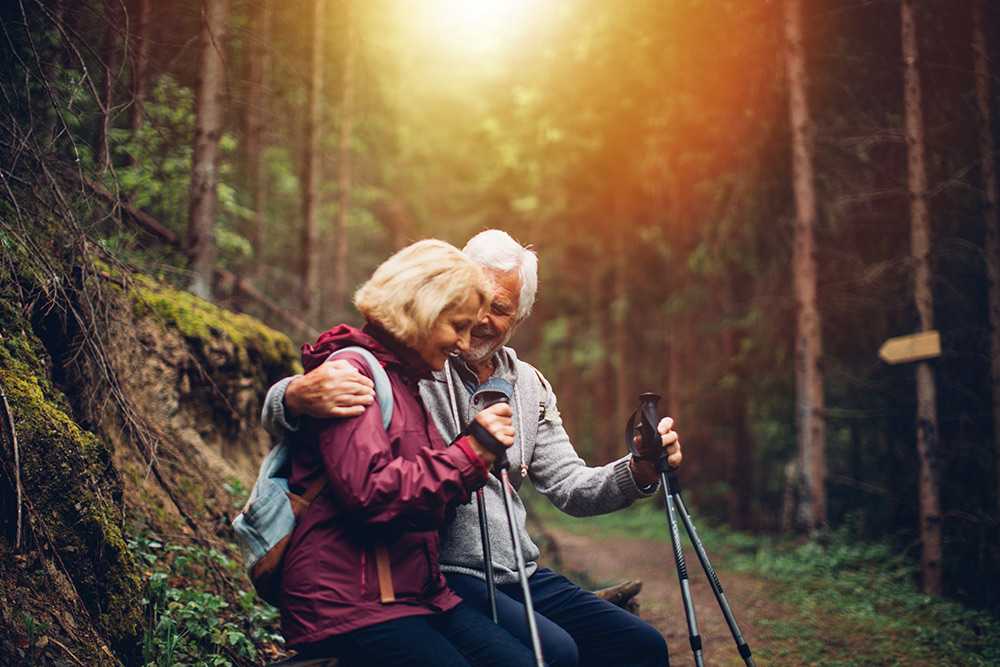 Elderly Couple Sitting in Forest